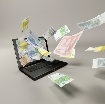 banknotes and laptop